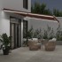 Toldo retráctil manual con luces LED marrón 600x350