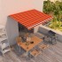 Toldo retráctil manual naranja y marrón 450x350
