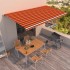 Toldo manual retráctil naranja y marrón 600x350